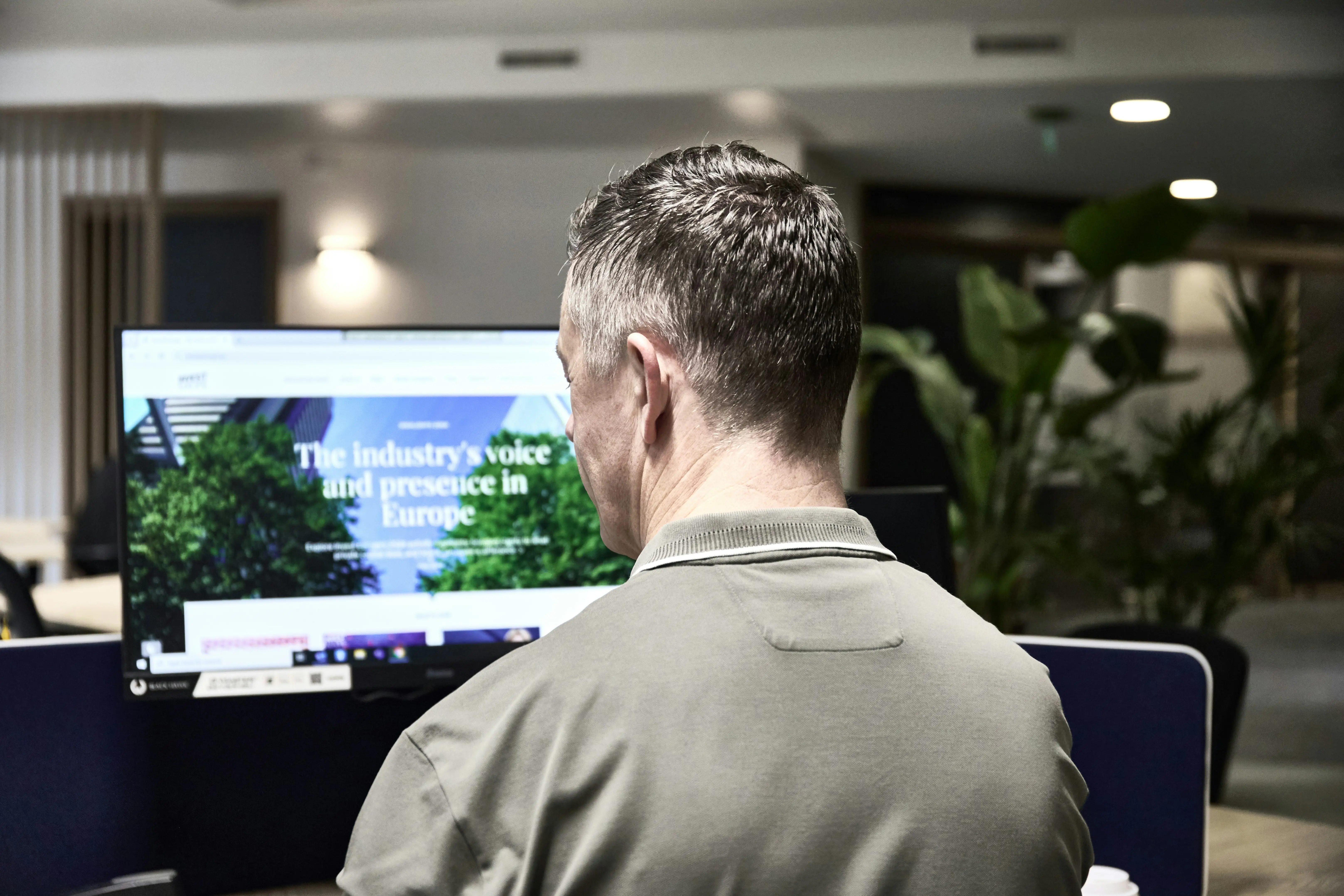 Business owner reviewing their new professional website on a large monitor